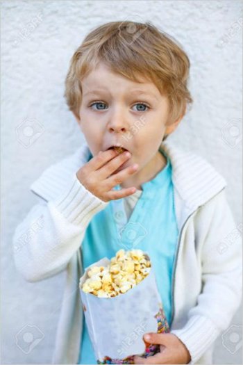 21016578-happy-little-boy-with-popcorn-bag-eating-sweets.jpg